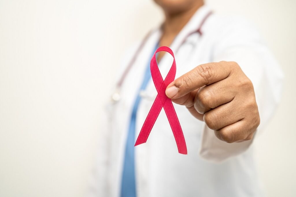 Breast cancer, Asian doctor woman with pink ribbon, symbol of Wo